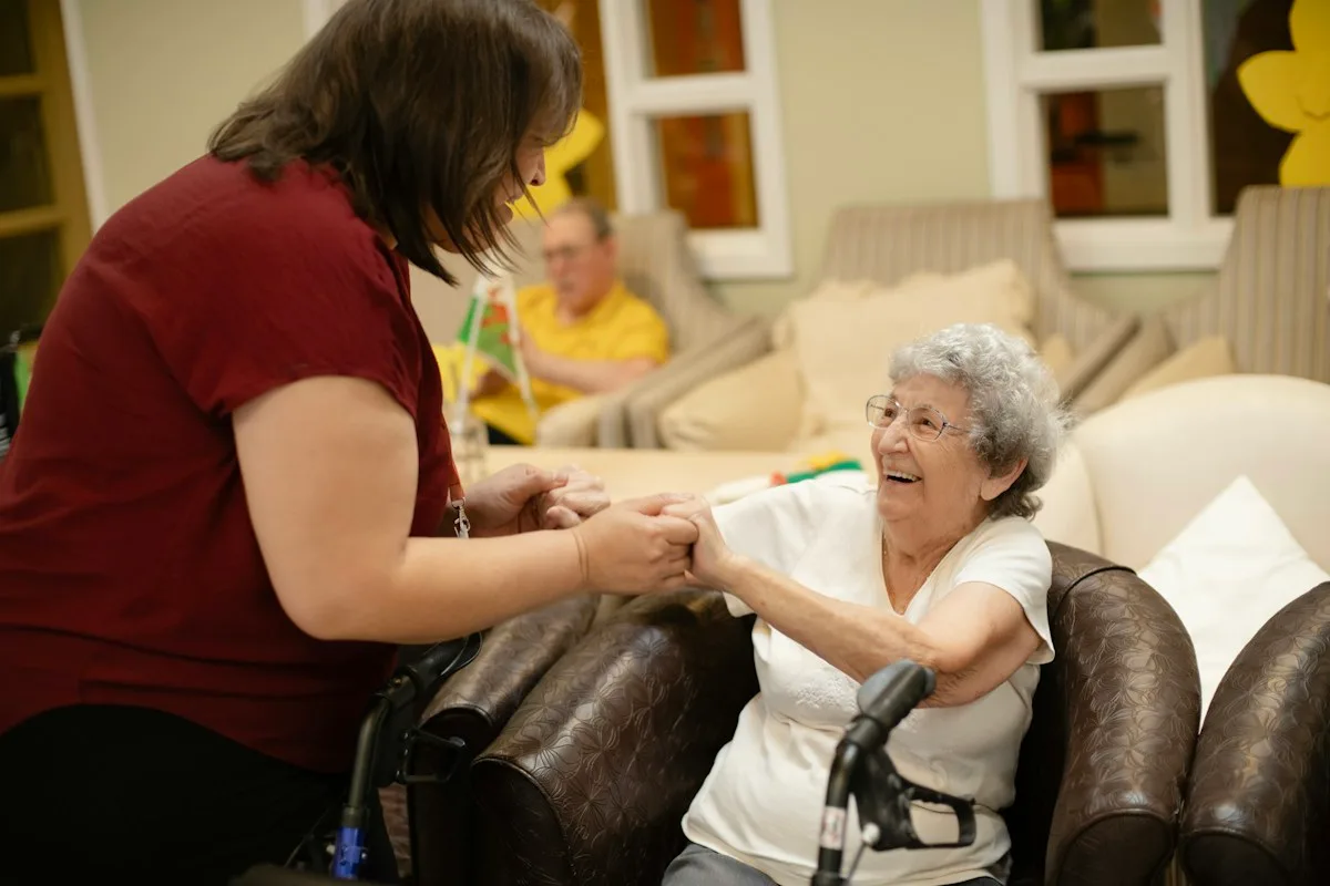 Care worker supporting an elderly woman, a role with special rules under the UK care worker visa