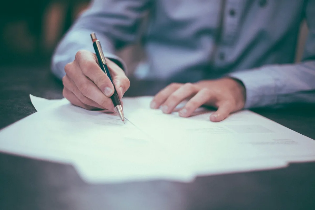 Student filling in a form while planning when to apply for scholarships